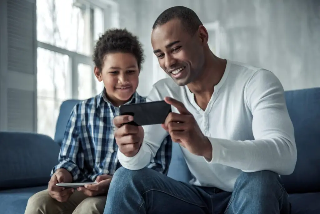 Father introducing son to phone