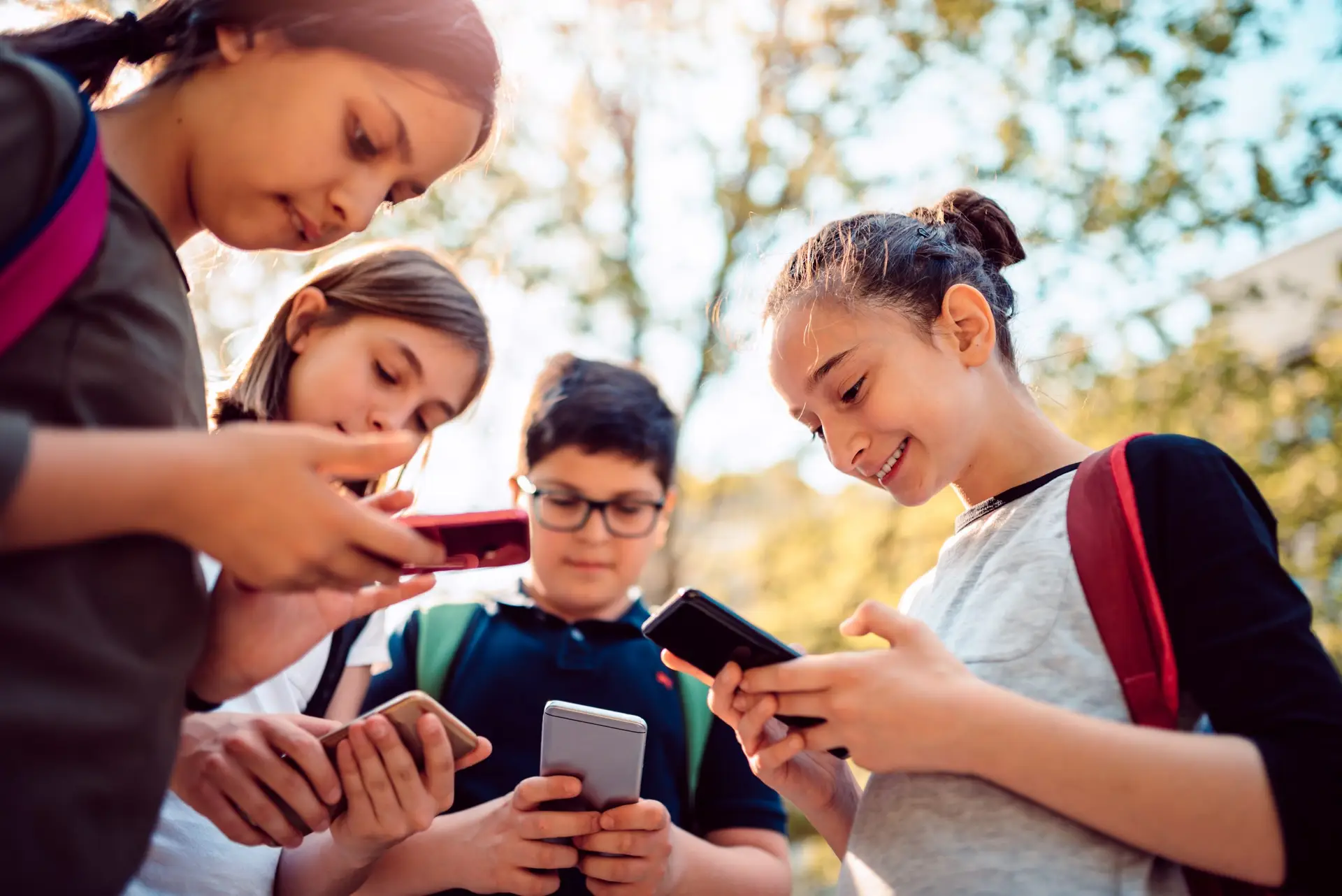 Kids using social media on smart phone after school