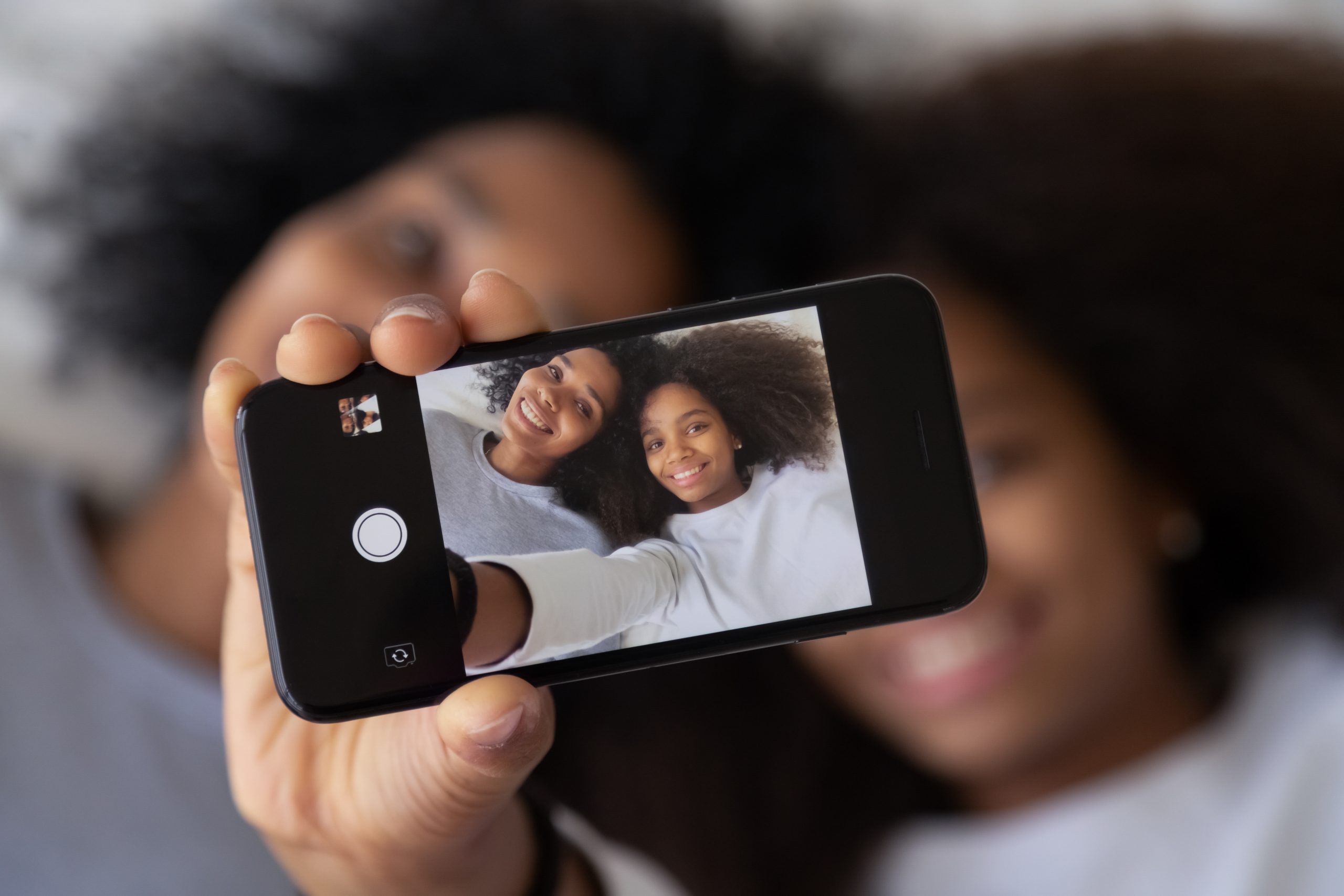 mom and daughter taking a selfie together