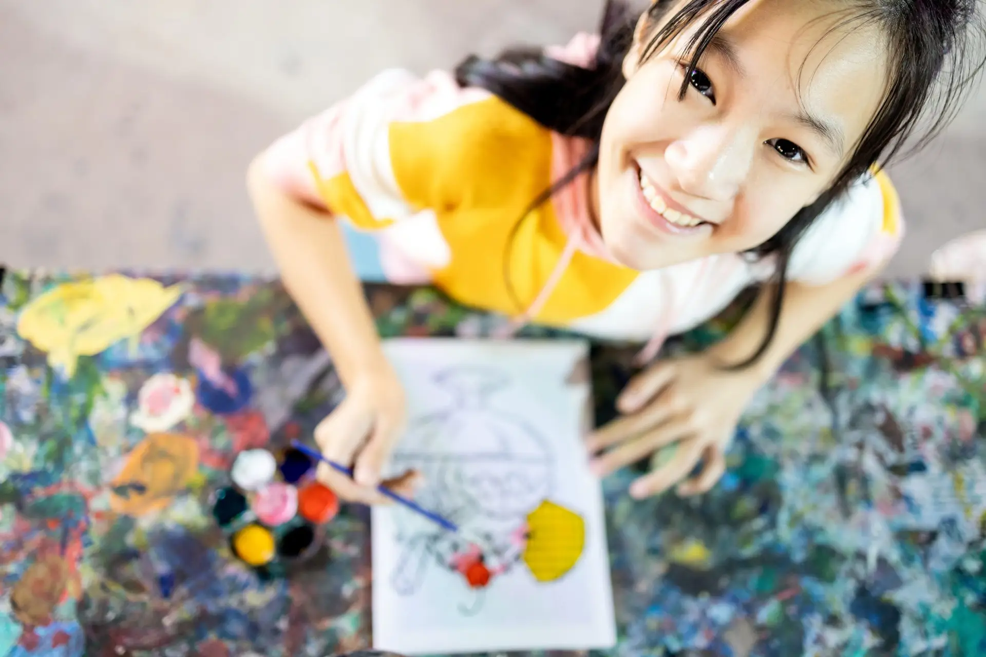 Top view,happy asian female people enjoy paint activities having fun,relax, smiling teenage girl with palette and paintbrush to painting watercolor on canvas, art,creativity,development of children