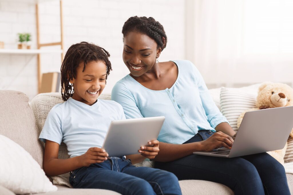 mom and daughter looking at computer