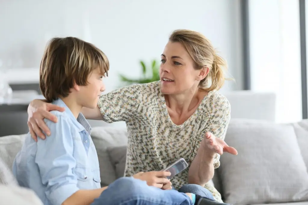 mom talking to her son on the couch