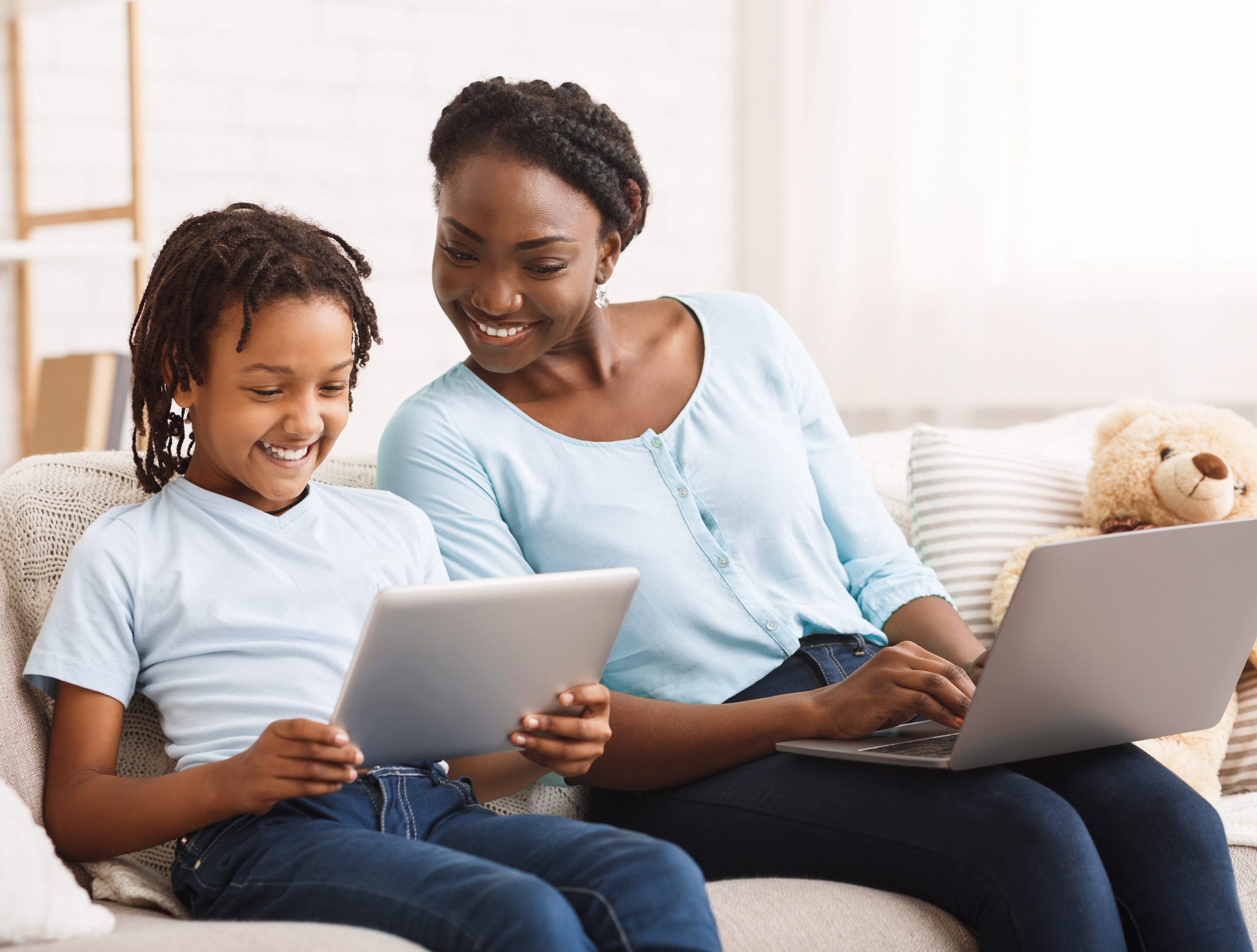 Mother and child enjoying screen time together. Mother is keeping kid safe online.