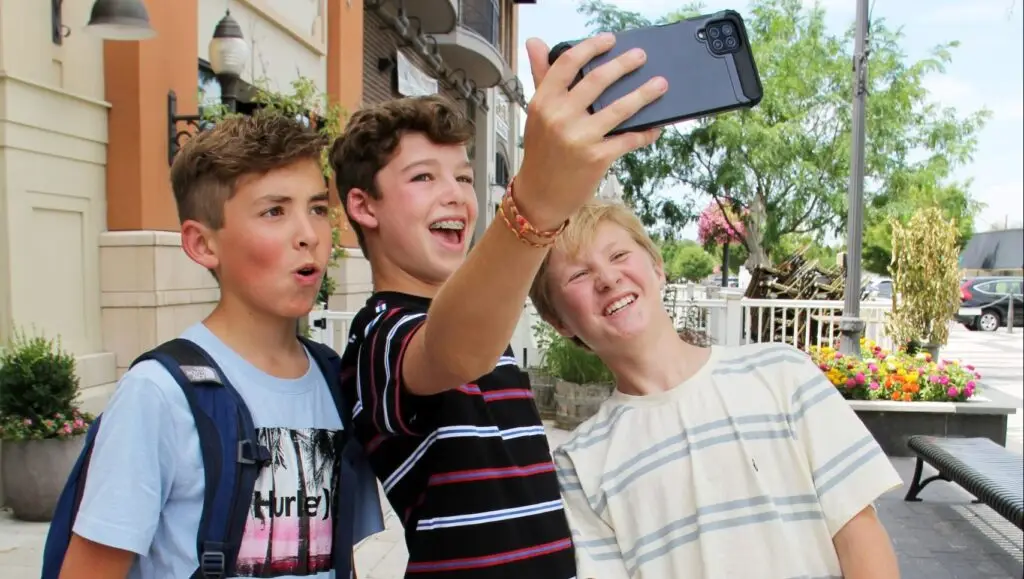 three teenage boys taking a selfie