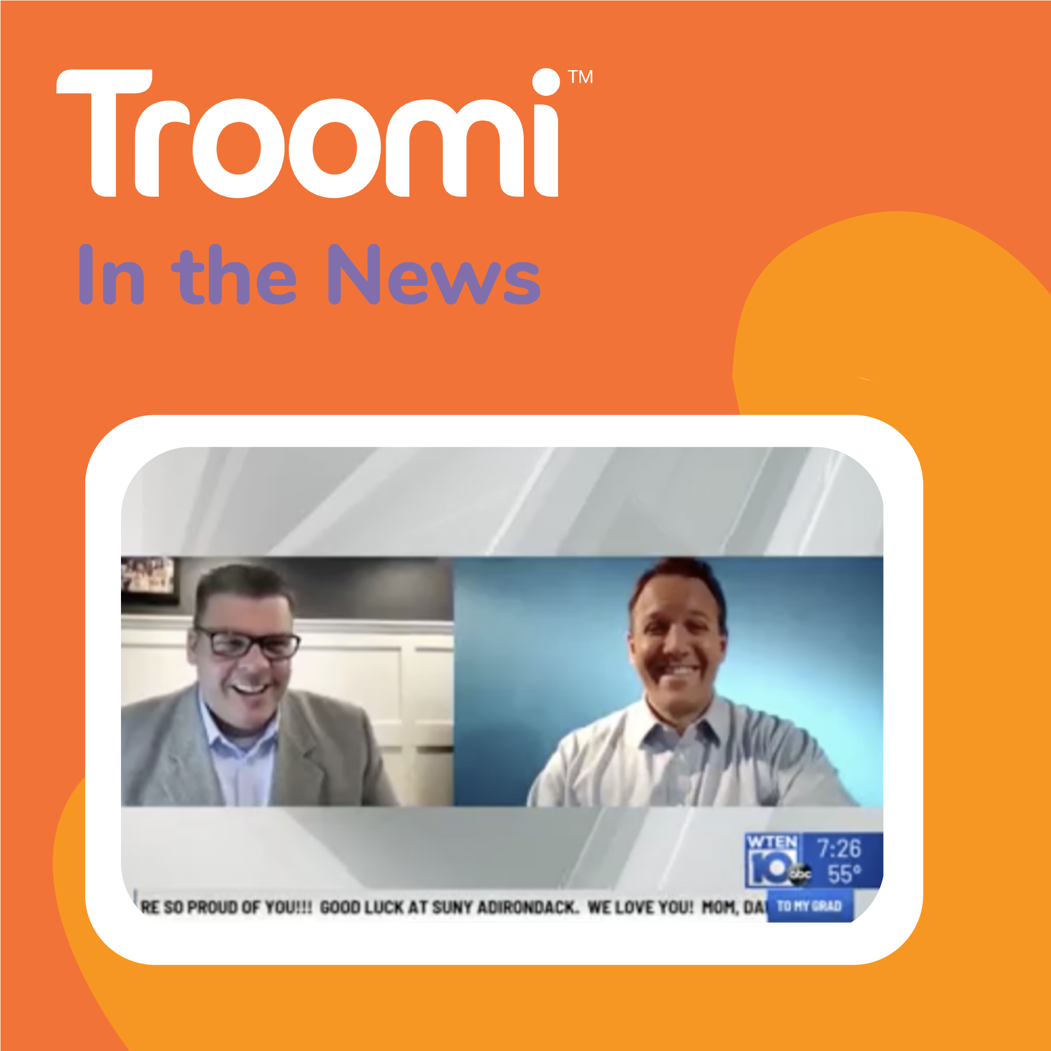 Two men in suits are on a video call, smiling. The screen features Troomi In the News on an orange background, highlighting their innovative phone that adjusts to your family’s needs. Below, a news ticker scrolls with congratulatory messages, celebrating this technological advancement.