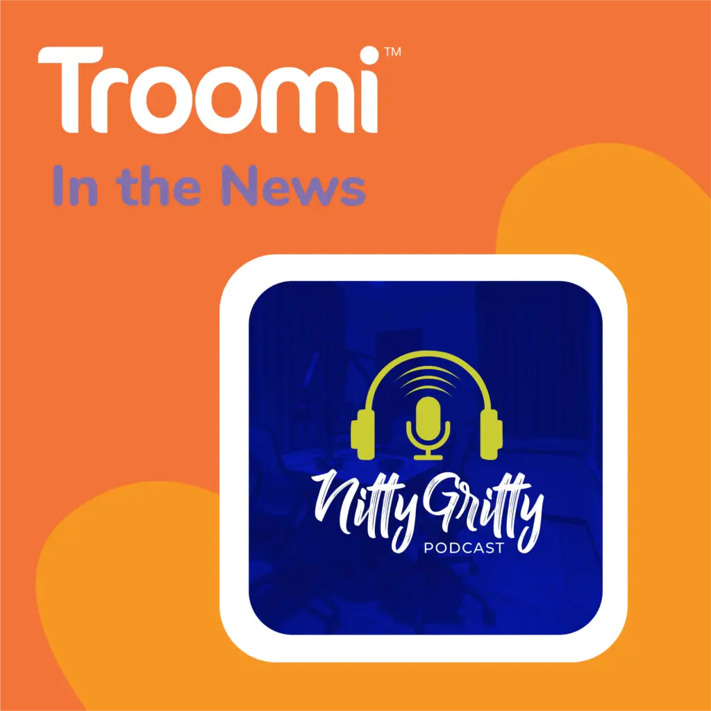 The image features an orange background with the text Troomi In the News. Below, a square graphic proudly showcases a microphone with headphones, emphasizing the Nitty Gritty Podcast against a dark blue backdrop.