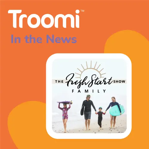 Graphic with an orange background featuring the text “Troomi In the News.” Below, a family walks on a beach holding surfboards, beside the logo “The Fresh Start Show Family.” Discover what you need to know about kids and cell phones in today’s tech-savvy world.