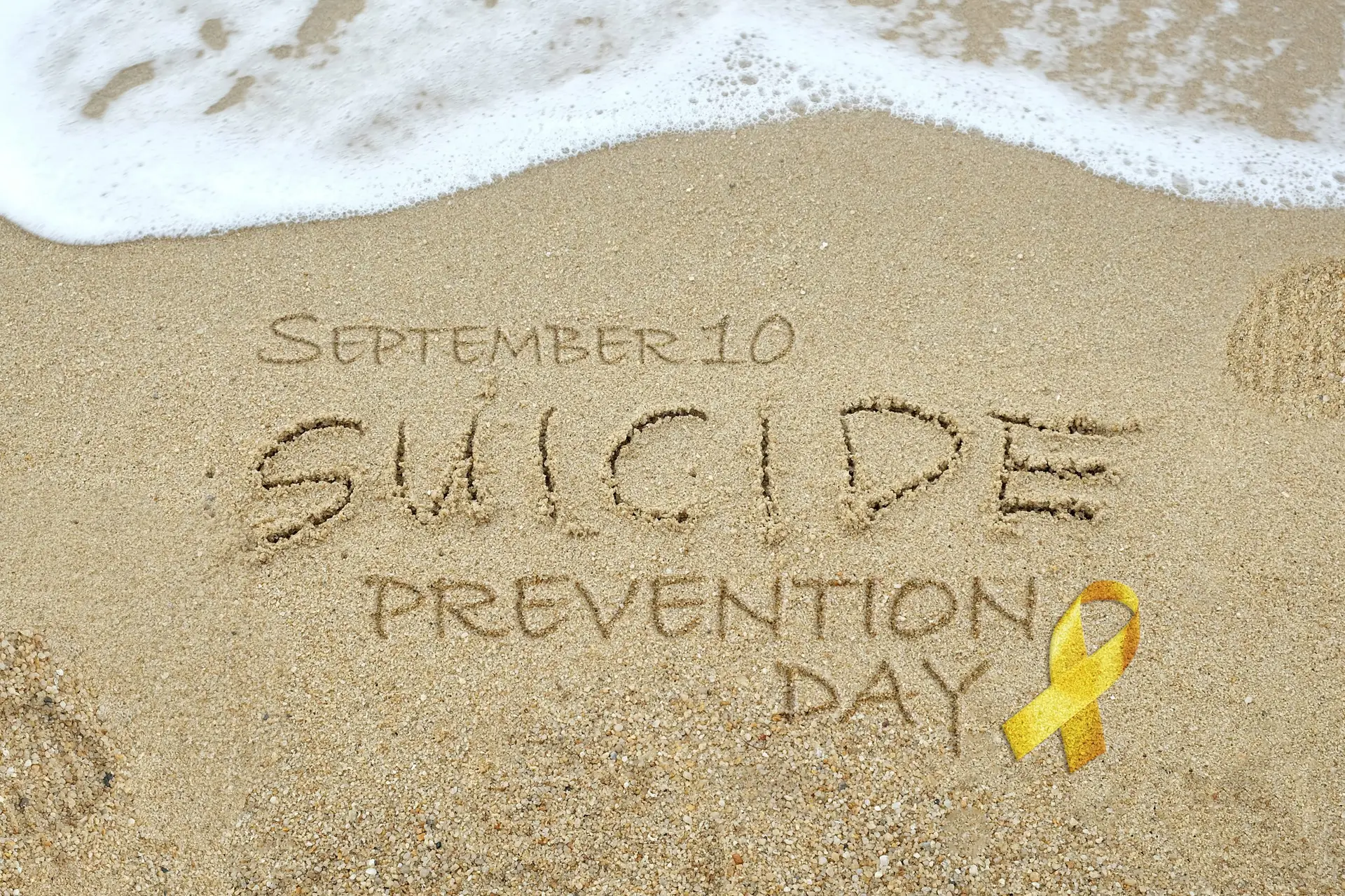 september 10 suicide prevention day written in the sand