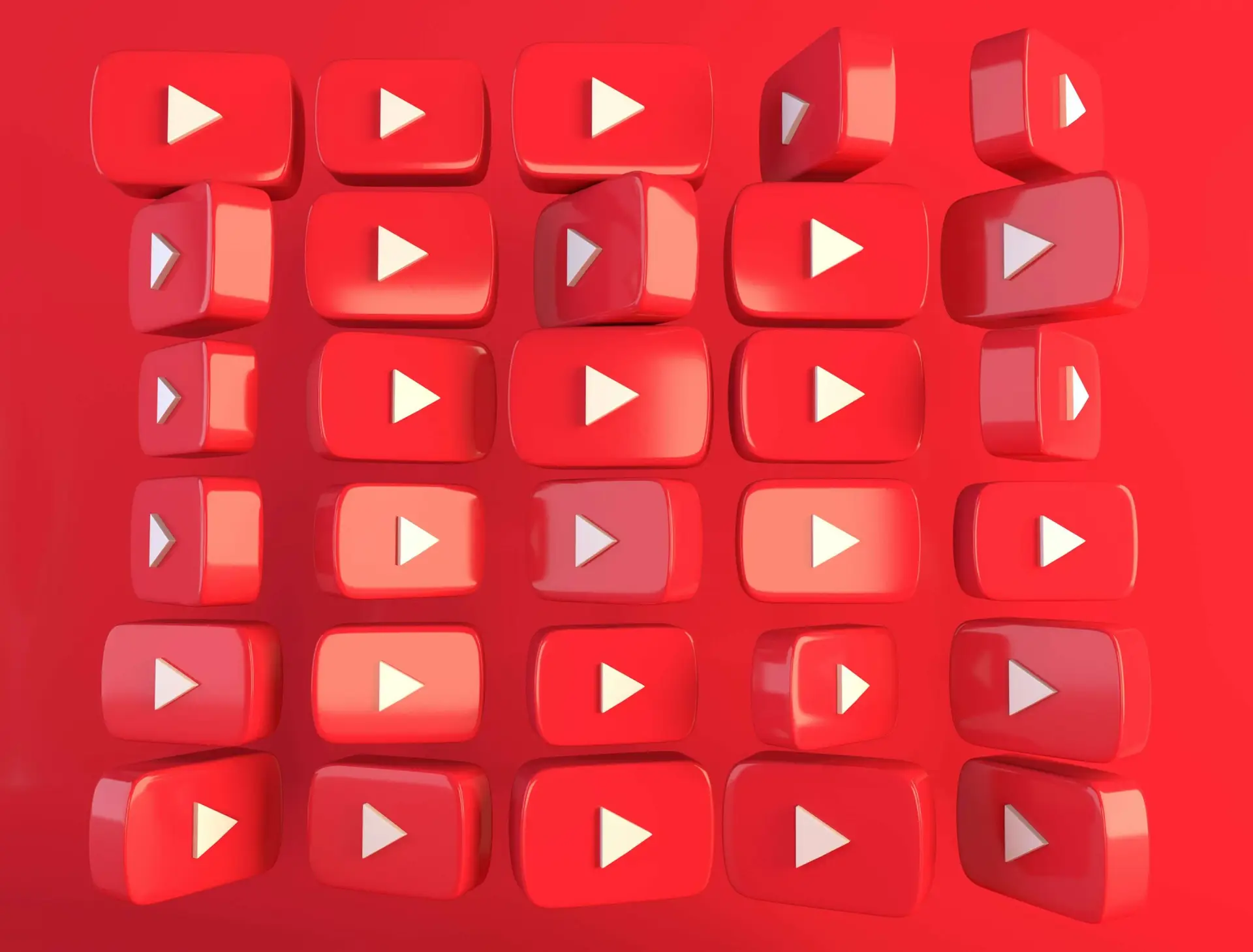 An array of 3D red play buttons with white triangles pointing right, resembling the YouTube logo, arranged in a grid pattern against a red background, evokes the vibrant world of YouTube videos for kids.