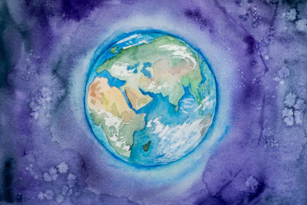 A watercolor painting of Earth, celebrating World Mental Health Day, set against a swirling purple and blue galaxy. The continents are vividly colored, with delicate brushstrokes creating a dynamic, ethereal atmosphere that highlights the planet's beauty in space.