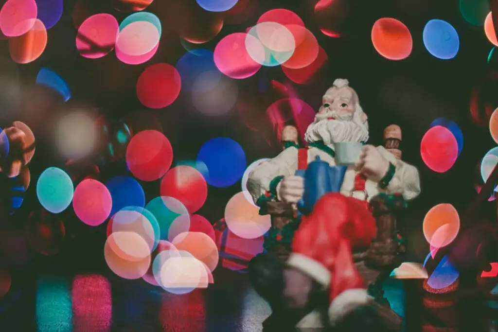 santa clause decoration sitting in a chair drinking something