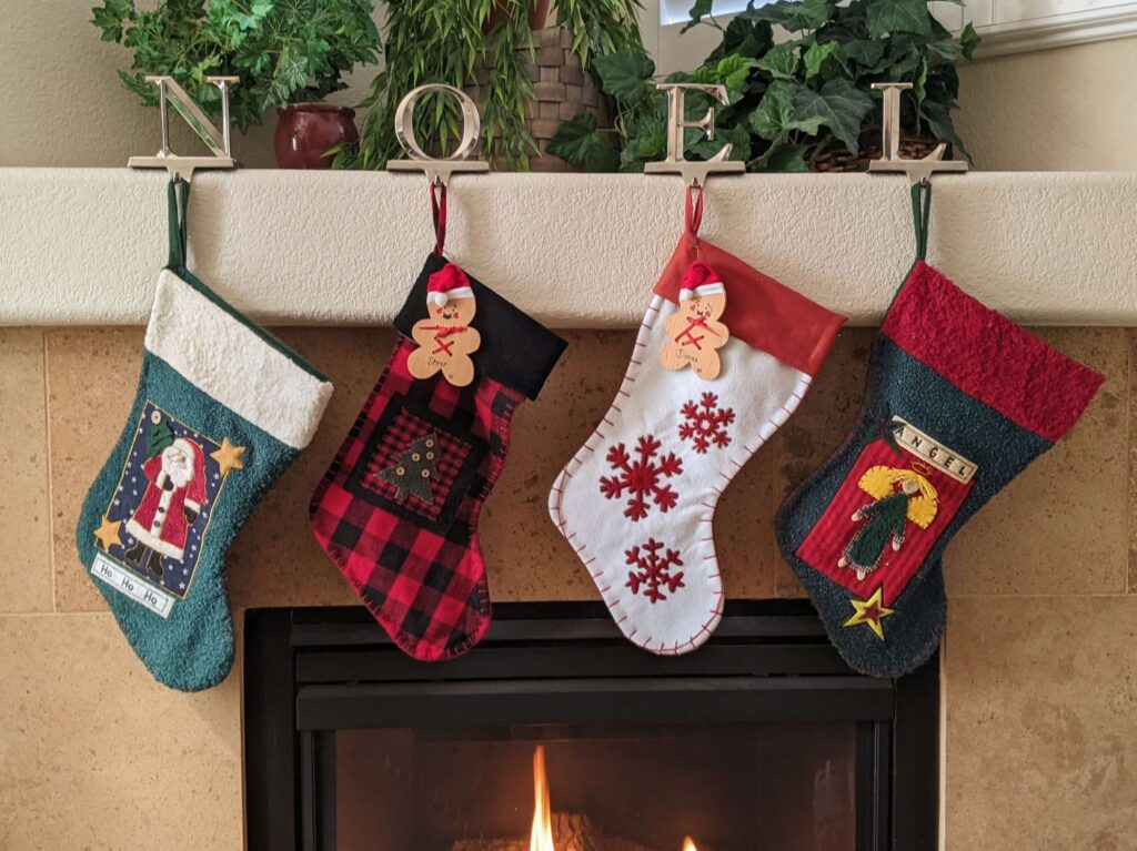 four christmas stockings over a fireplace