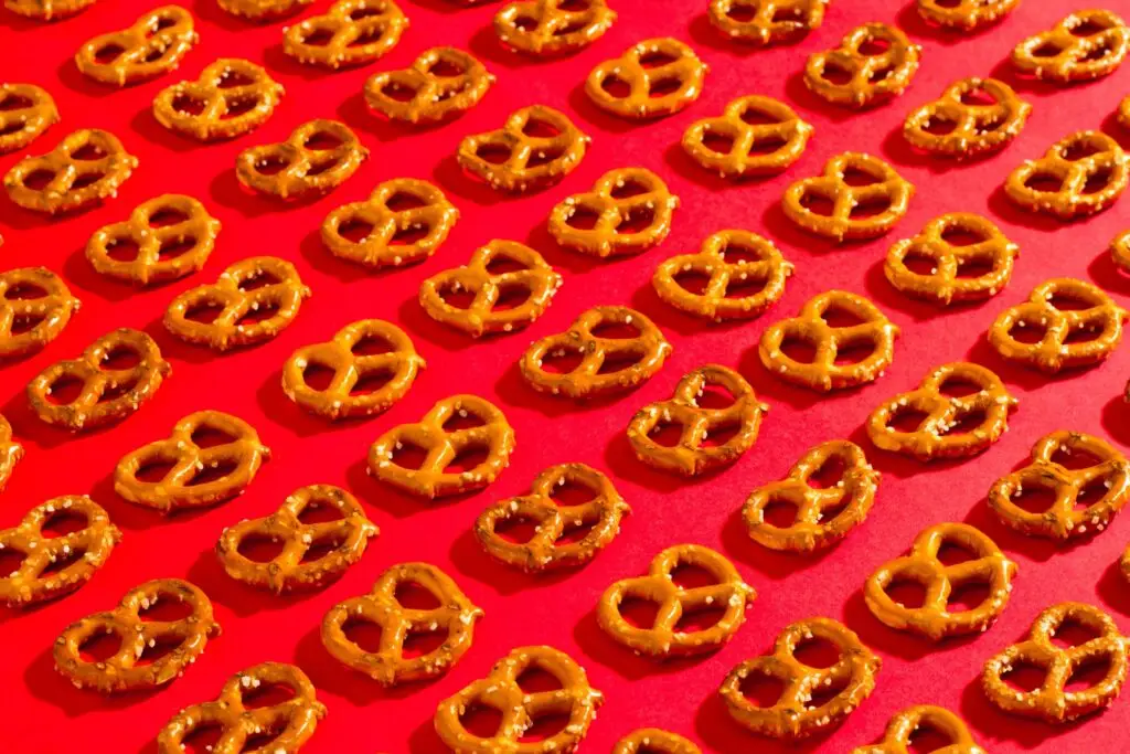 rows of pretzels on a red mat