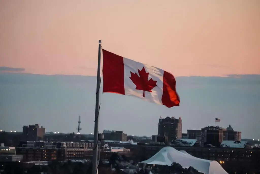 the canadian flag with the city in the background