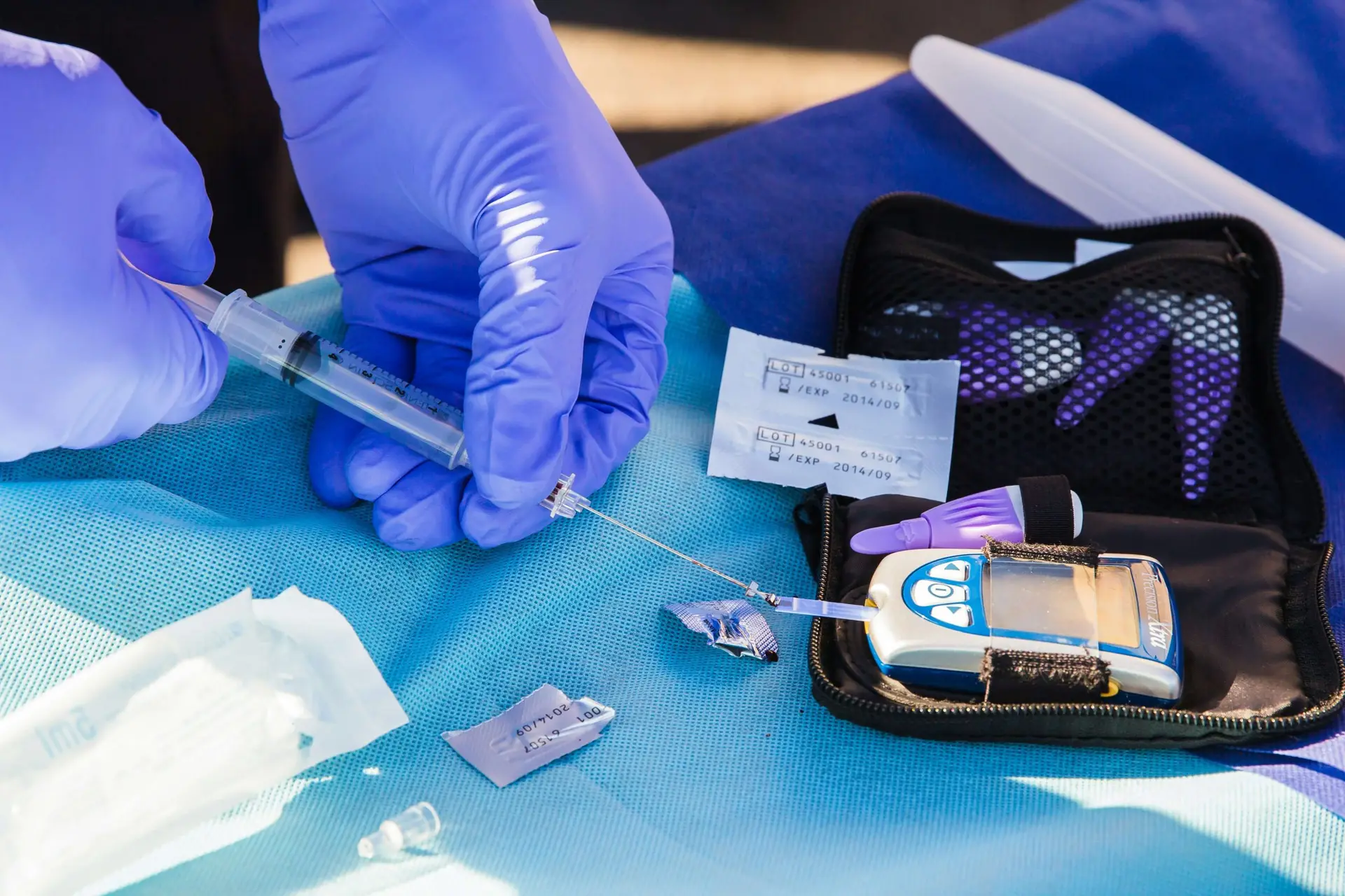 person testing a blood glucose meter