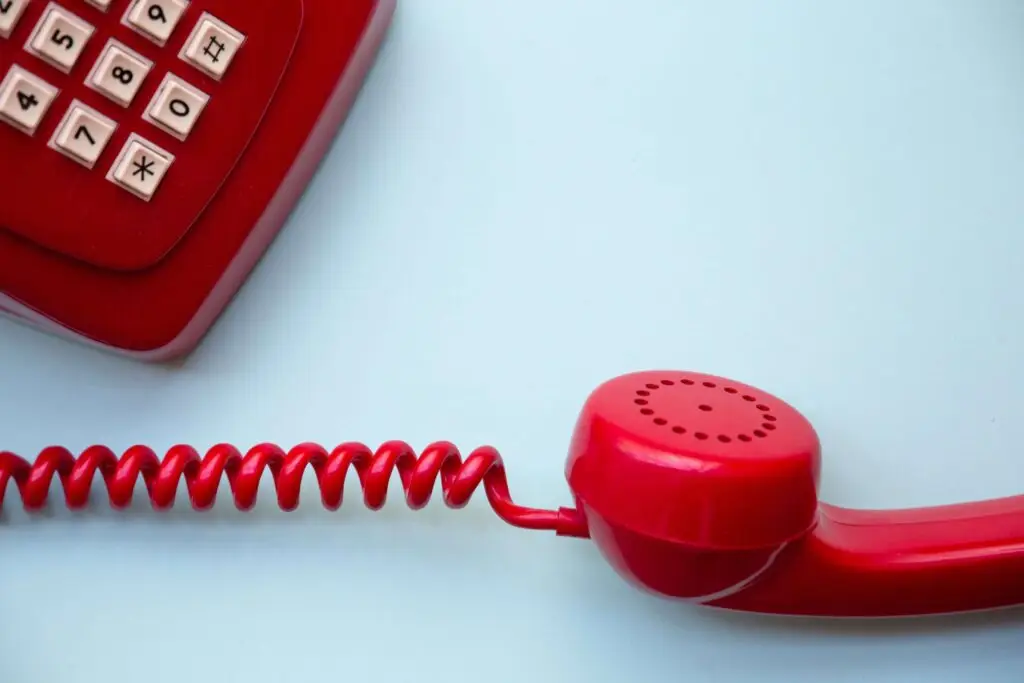 close up of red corded phone