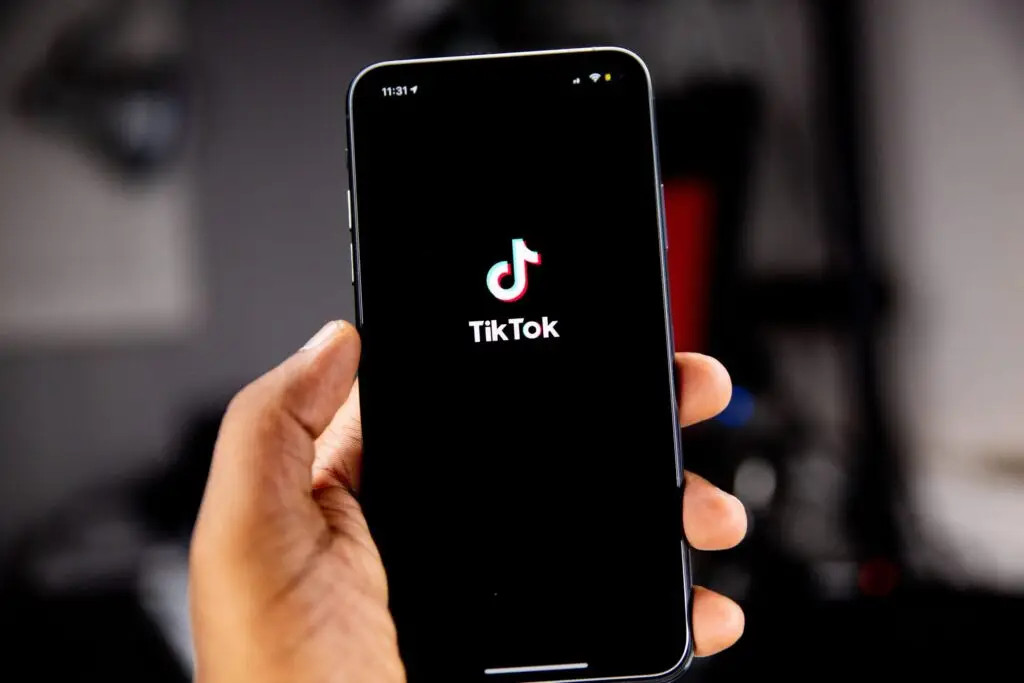 person holding a smartphone with the tiktok logo on it