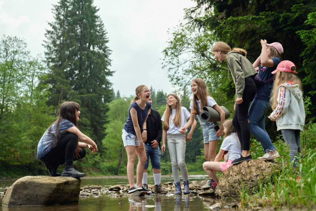 teenage girls having fun by the river