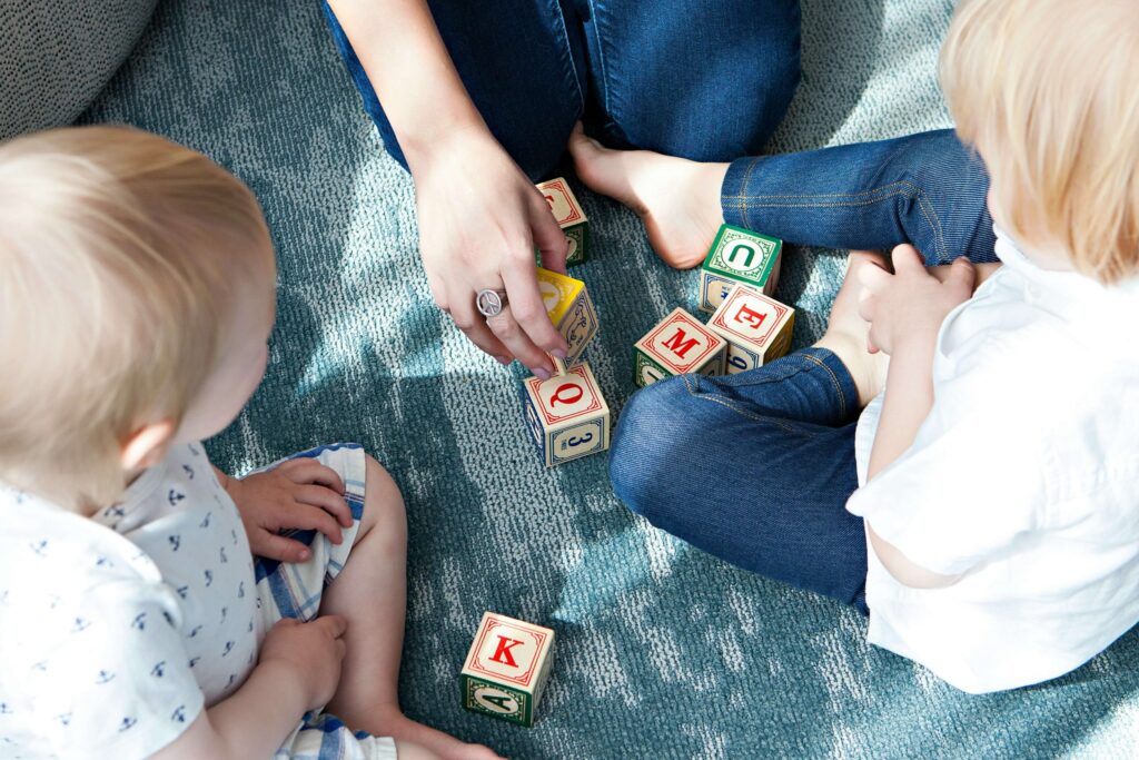 kids playing blocks with their mom