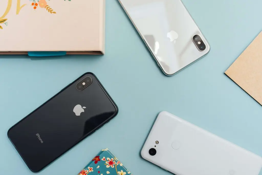 three smartphones upside down on a table