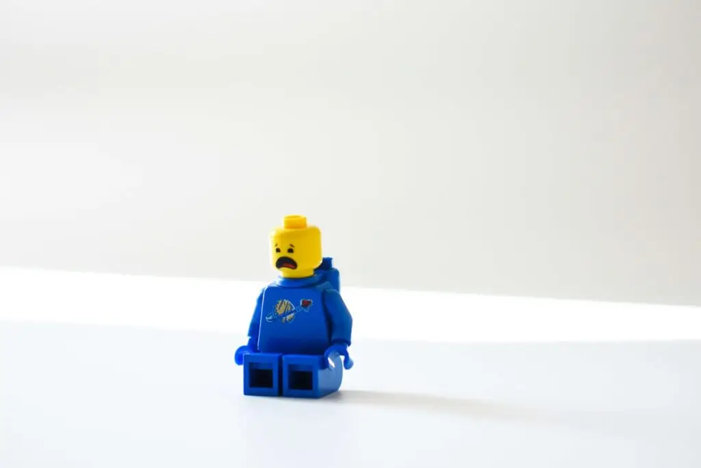 blue lego with frowning face