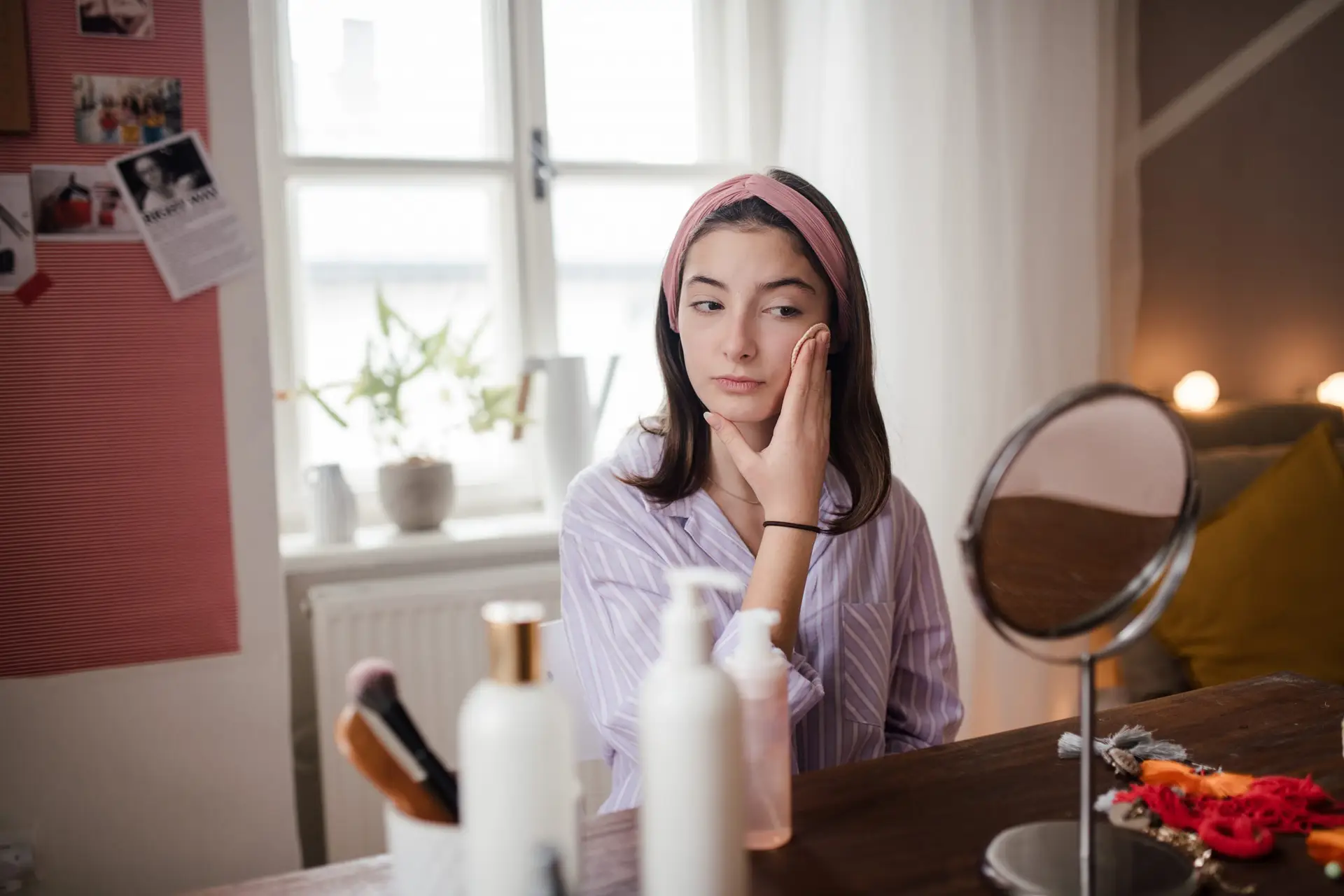 teenage girl taking off her make up