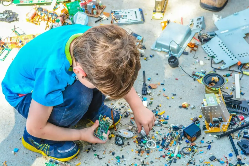 little boy rebuilding electronics