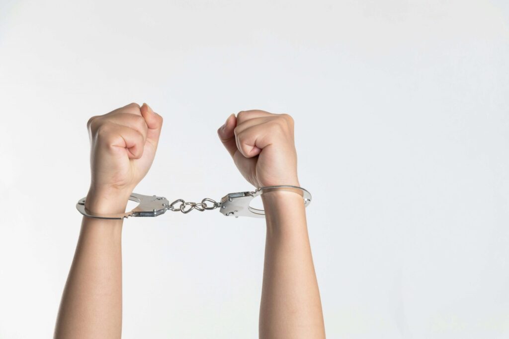 person in handcuffs