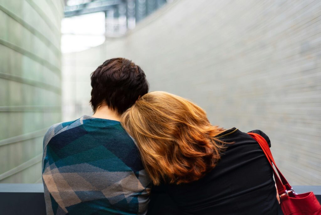 redhead woman leaning on person with brown hair