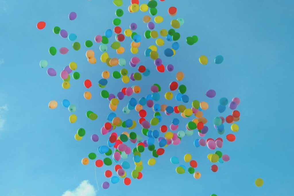 colorful balloons floating into the sky