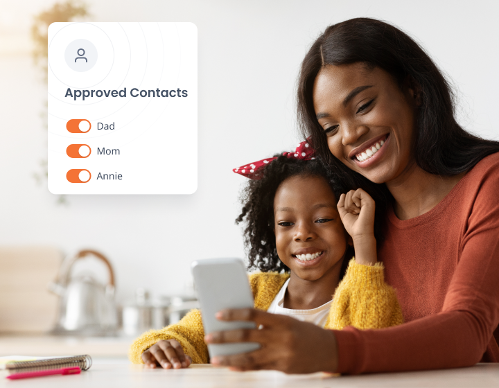 A mother and daughter smiling as they look at a smartphone together. A graphic beside them displays Approved Contacts with toggles for Dad, Mom, and Annie.