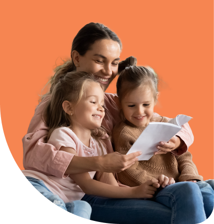 A woman happily reads a book with two young girls sitting on her lap against an orange background. They all appear engaged and joyful.