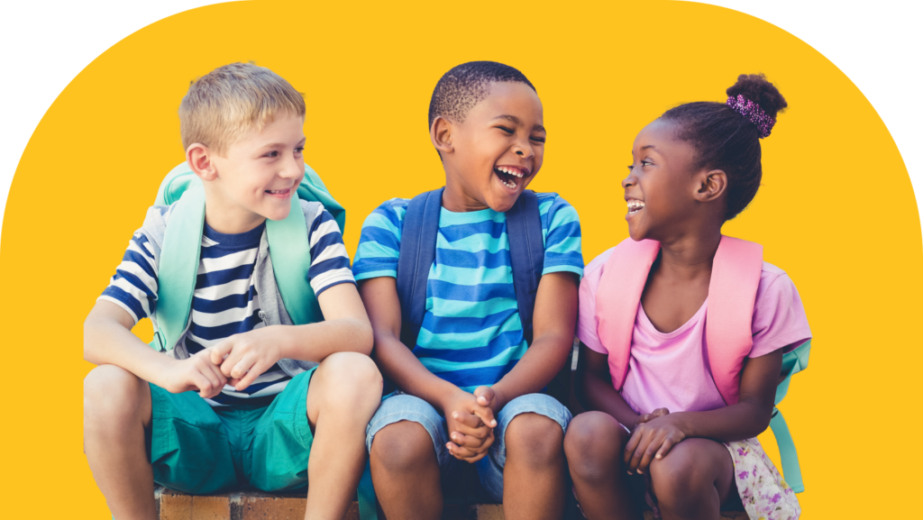 Three children sitting and laughing, wearing casual summer clothes and backpacks. They are sitting against a bright yellow background, enjoying a cheerful moment together.