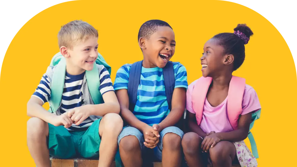 Three children sitting and laughing, wearing casual summer clothes and backpacks. They are sitting against a bright yellow background, enjoying a cheerful moment together.