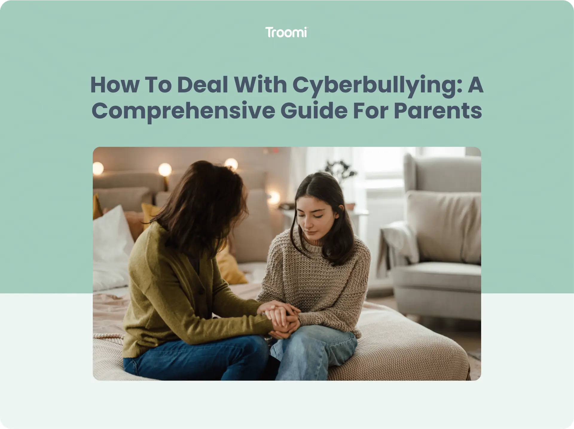 A mother and daughter sit on a bed, holding hands and talking seriously. The room is softly lit, with cushions and a lamp in the background. The text above them reads, How To Deal With Cyberbullying: A Comprehensive Guide For Parents.