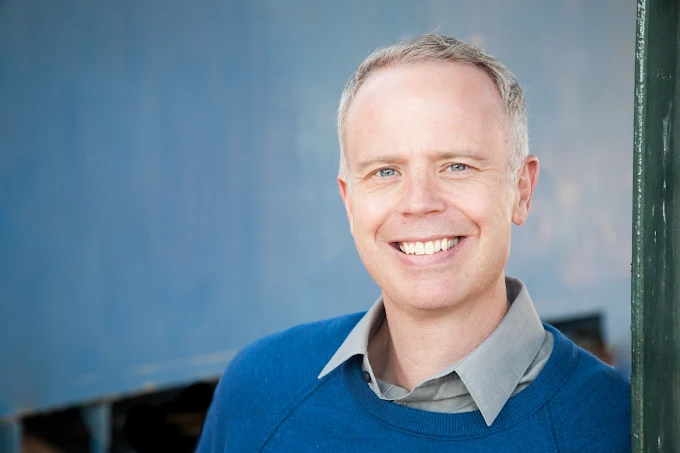 Jeff Gregson stands in front of a blue background, ready to discuss the technology impact on mental health.