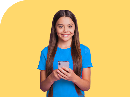 Smiling girl with long brown hair wearing a blue shirt holds a smartphone in both hands, standing in front of a yellow background.