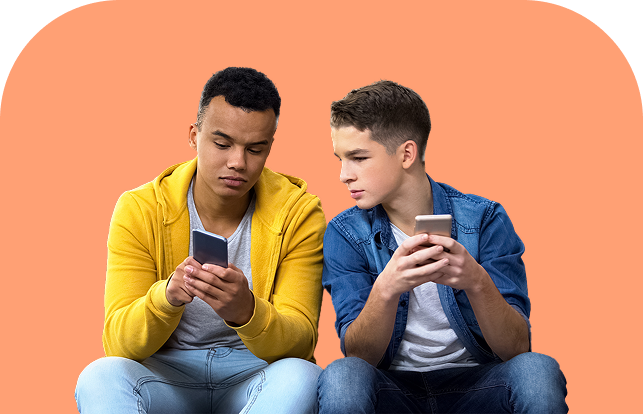 Two teenage boys sitting side by side, each holding a smartphone. One boy in a yellow hoodie looks at his phone, while the boy in a denim shirt leans in, appearing curious about the other’s screen. Orange background.