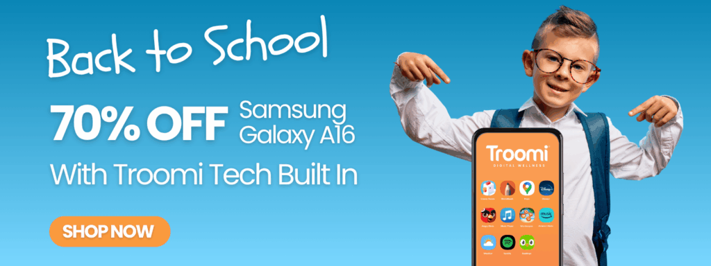 Young boy with glasses and backpack points at a large phone displaying the Troomi app, showcasing our mission. Text reads Back to School, 70% OFF Samsung Galaxy A16 with Troomi Tech Built In. Orange Shop Now button on blue background.