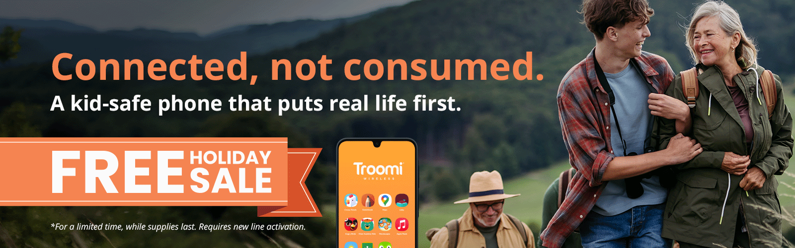 Three people hike outdoors smiling; a young man snaps a photo with his Troomi kids safe phone, walking with an older woman. Text reads, Connected, not consumed. A phone that puts real life first. FREE HOLIDAY SALE. Troomi phone image included.