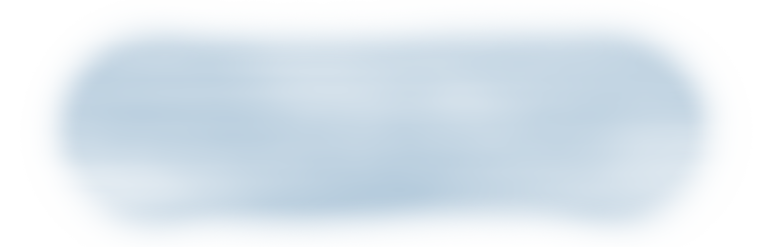 A blurry, abstract blue shape with soft edges on a white background, resembling a watercolor or cloud-like form.