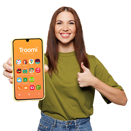 A smiling woman in a green shirt holds up a yellow smartphone displaying the Troomi homepage and gives a thumbs up with her other hand. The phone screen shows colorful app icons on an orange background.
