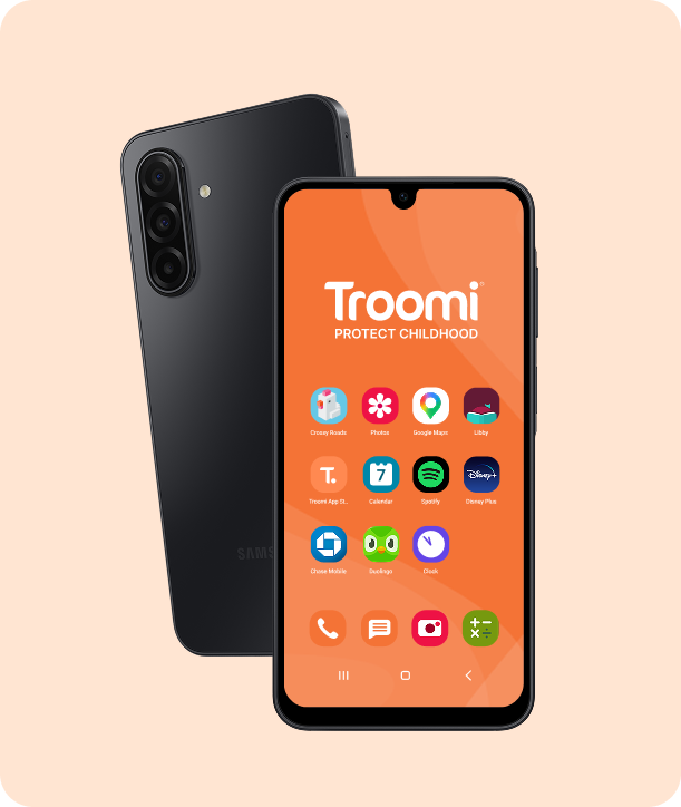 A black Samsung smartphone with an orange screen displaying the Troomi logo, tagline Protect Childhood, and various app icons such as Google Maps, Disney Plus, and Zoom. The phone rests on a light peach background.