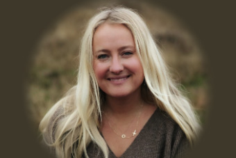 Parent blogger Courtney Casper is shown in a field smiling