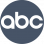 The image shows a circular logo with the lowercase letters abc in black, centered within a dark gray circle.