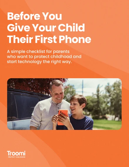 A smiling man and child look at a smartphone together outdoors. Text above reads: Before You Give Your Child Their First Phone. A simple checklist for parents who want to protect childhood and start technology the right way..